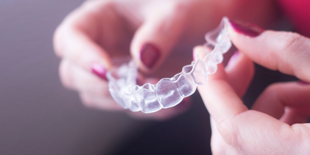 invisalign being held by dentist