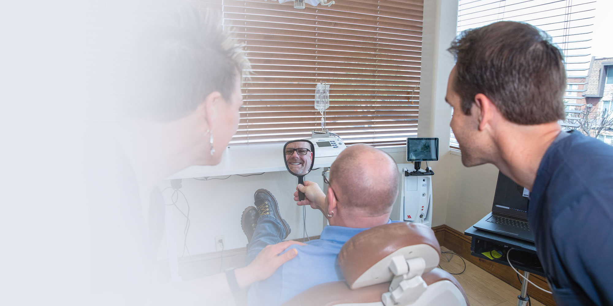 rodney with mirror looking at new smile