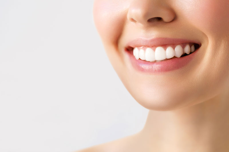 Perfect healthy teeth smile of a young woman. Teeth whitening. Dental clinic patient. Image symbolizes oral care dentistry, stomatology.