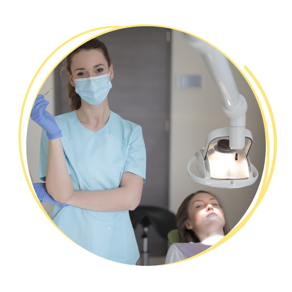 dental assistant standing next to dental chair with patient in it