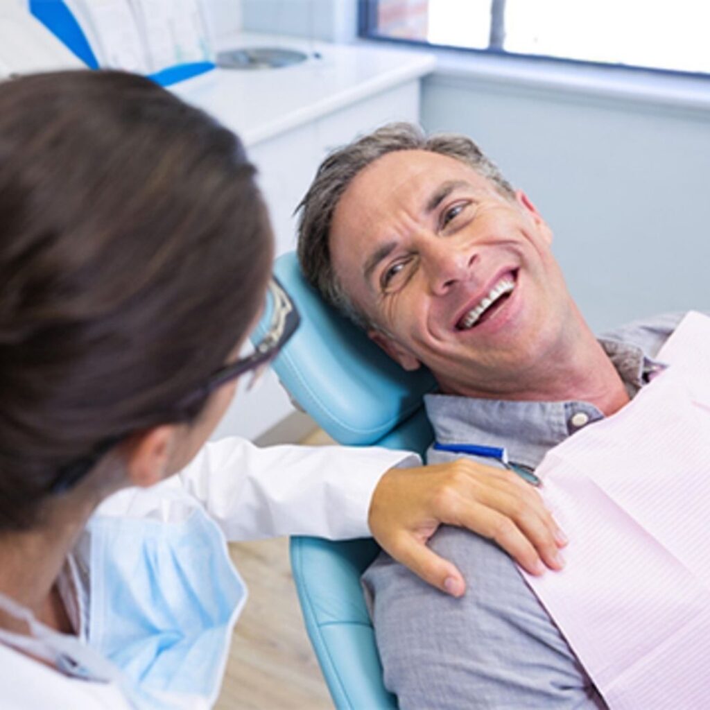 patient smiling at dentist in dental chair