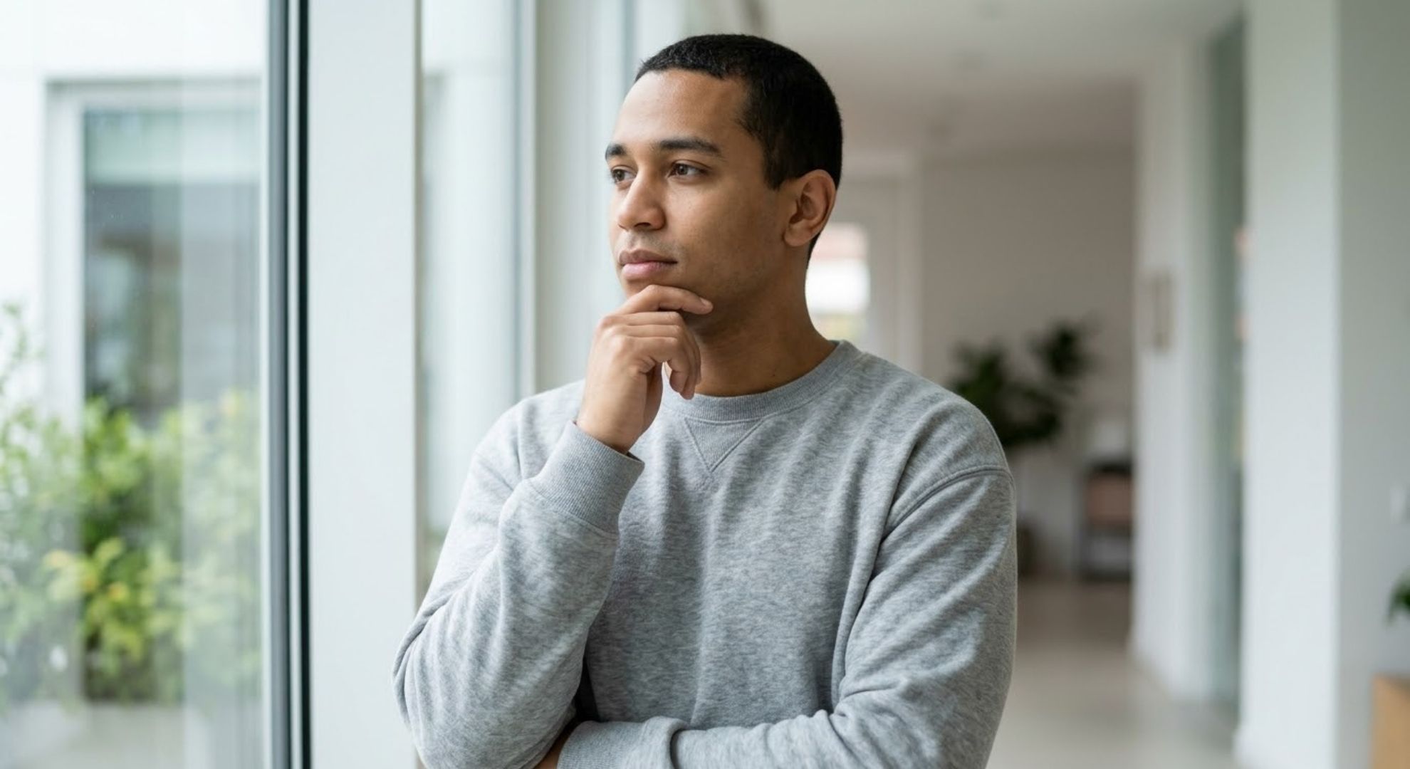 man thinking, looking out the window