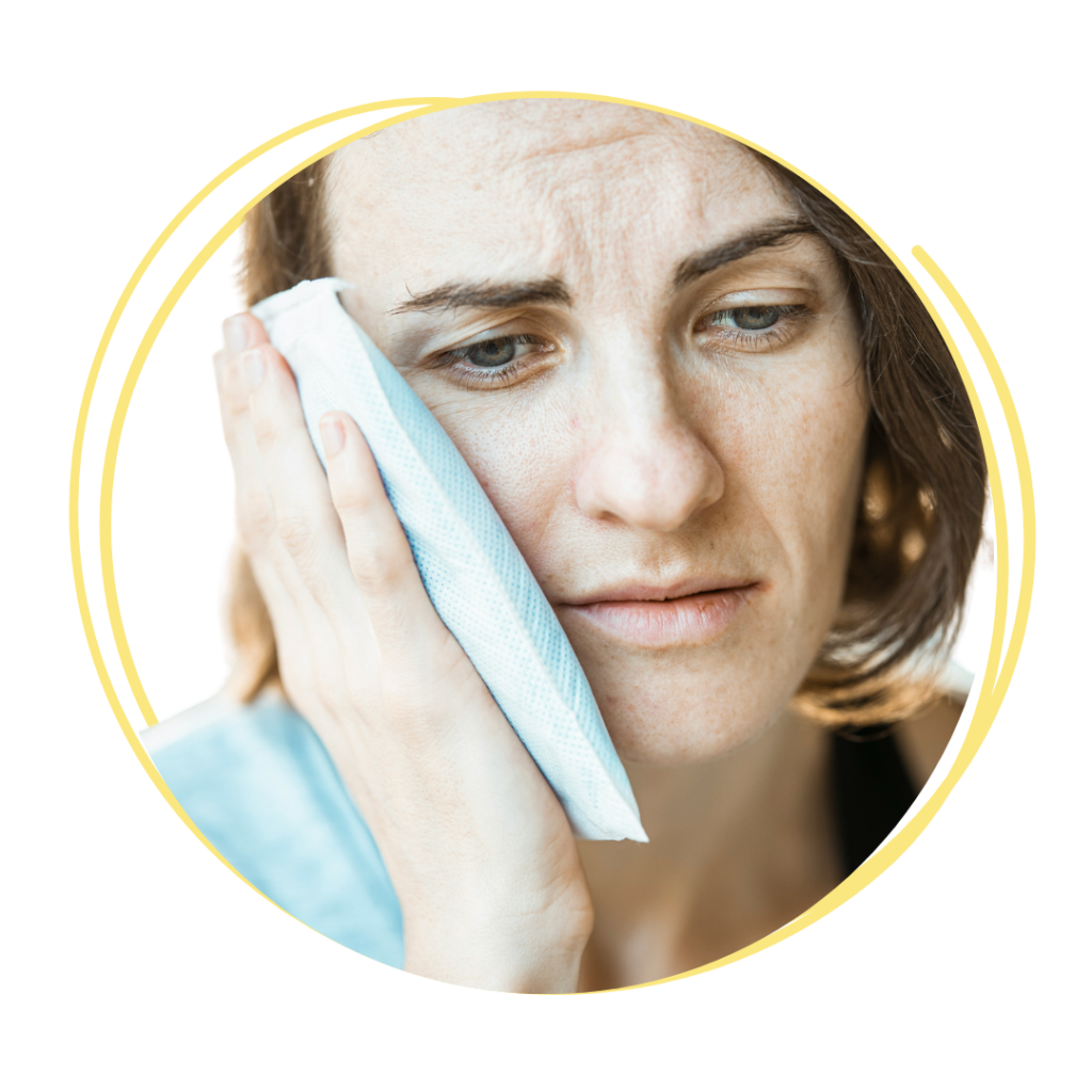 woman holding ice pack up to her cheek