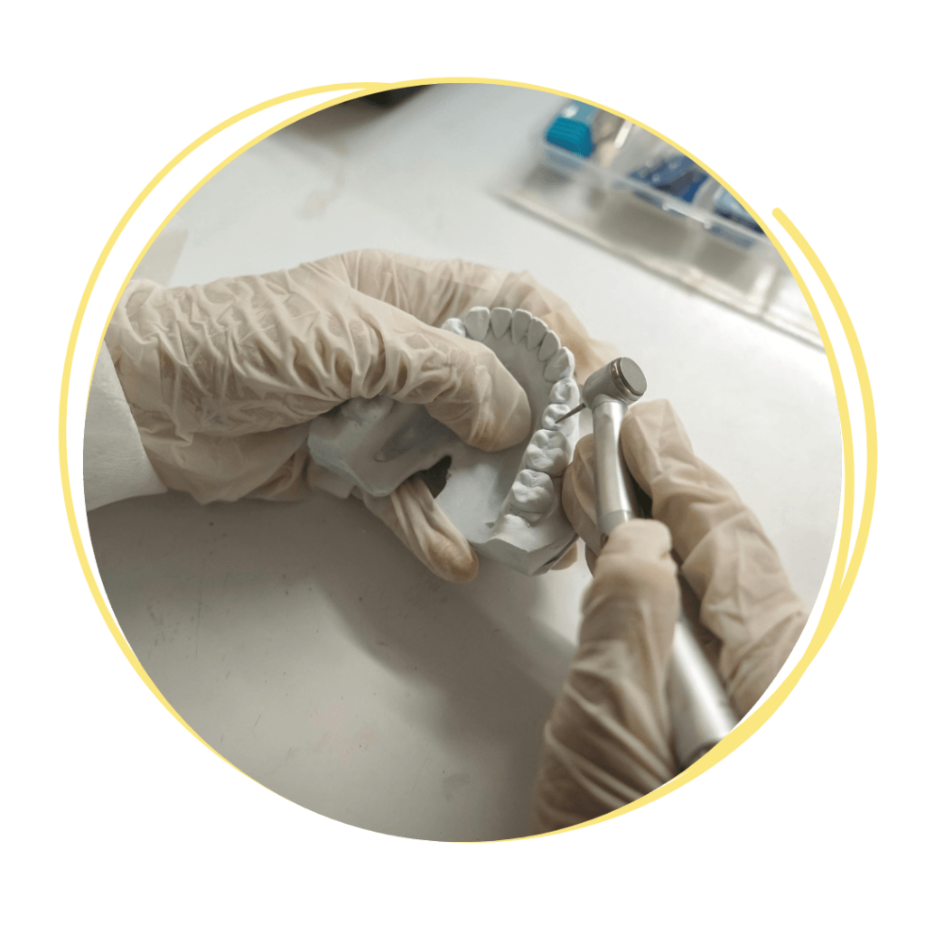 Image of a dentist making implants on a model