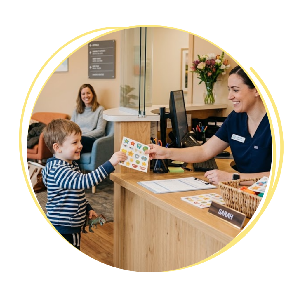child getting stickers/prize from front desk